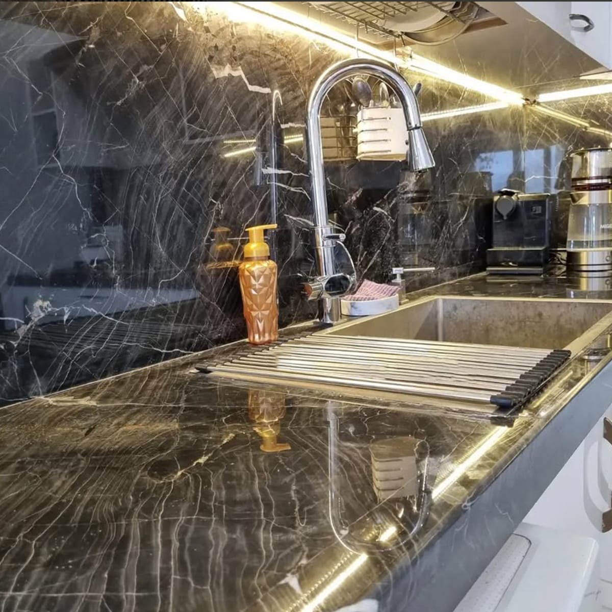 3D Black Marble backsplash behind kitchen sink, featuring deep black tones and striking veining for a modern design.