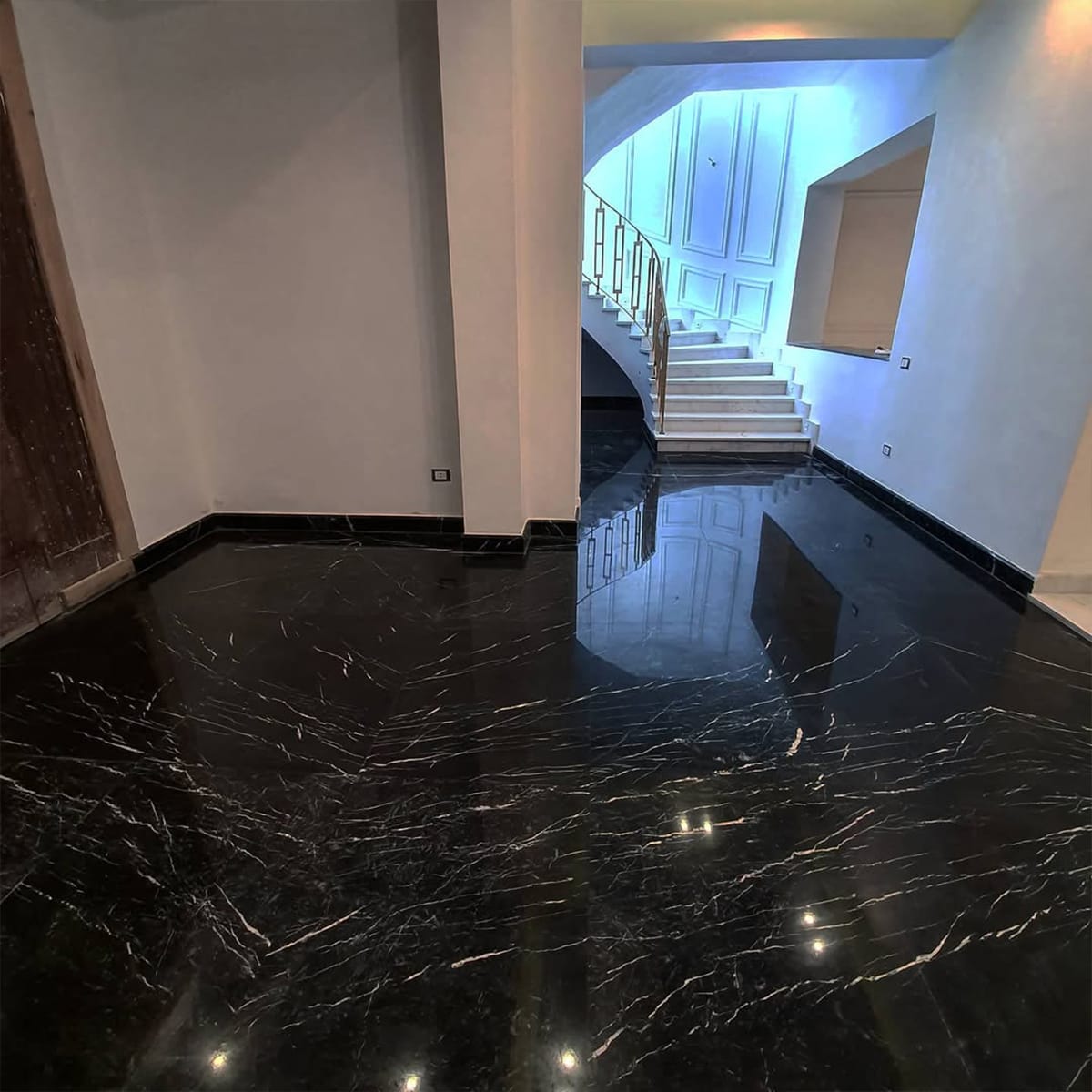 Nero Marquina marble flooring in a modern home living room