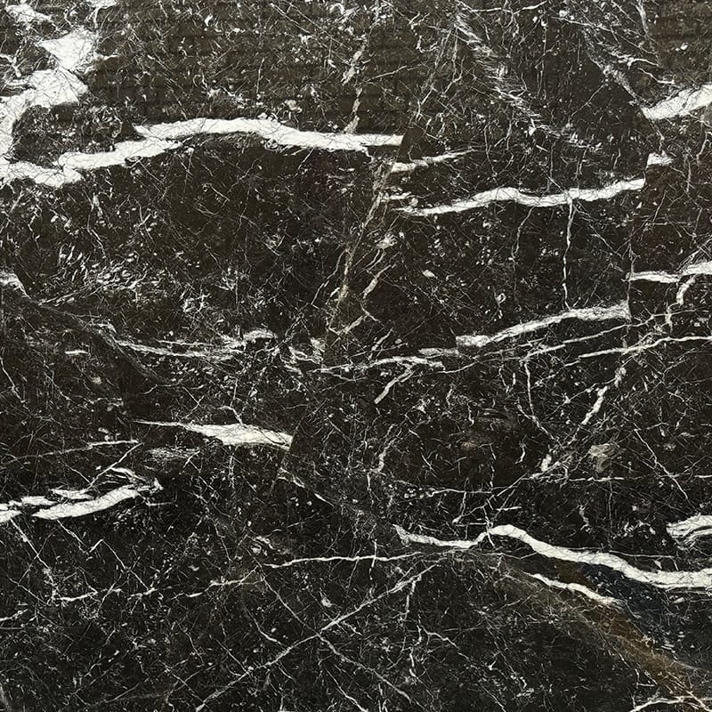 Close-up of Nero Marquina Marble pattern with bold white veining on black background