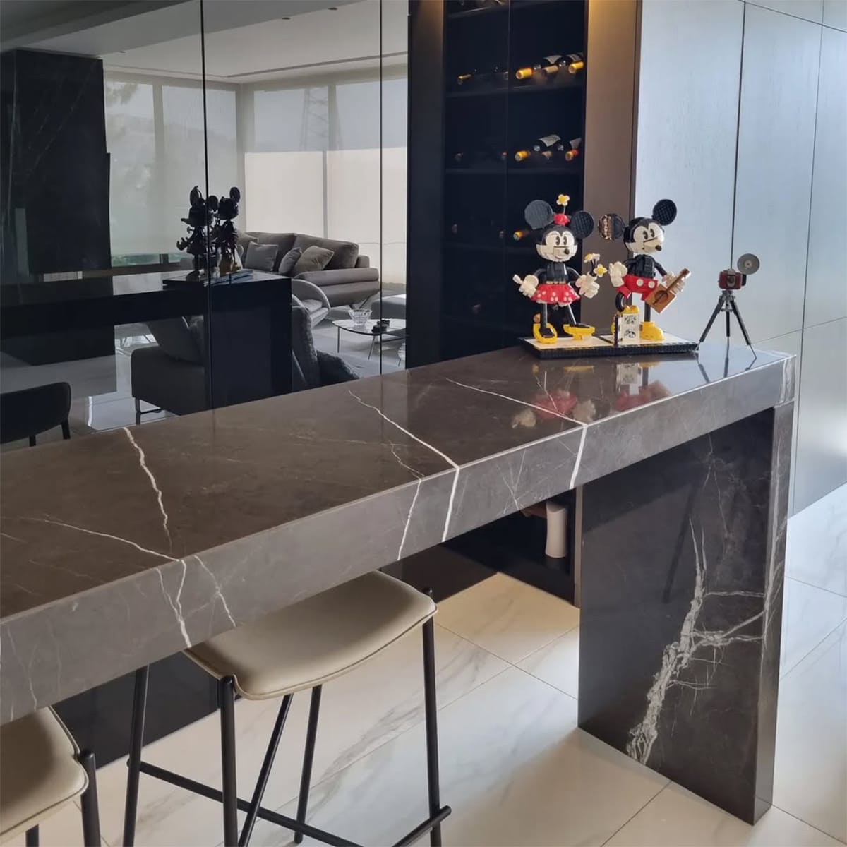Modern kitchen island featuring Pietra Gray Marble countertop with a deep gray base and elegant white veining.
