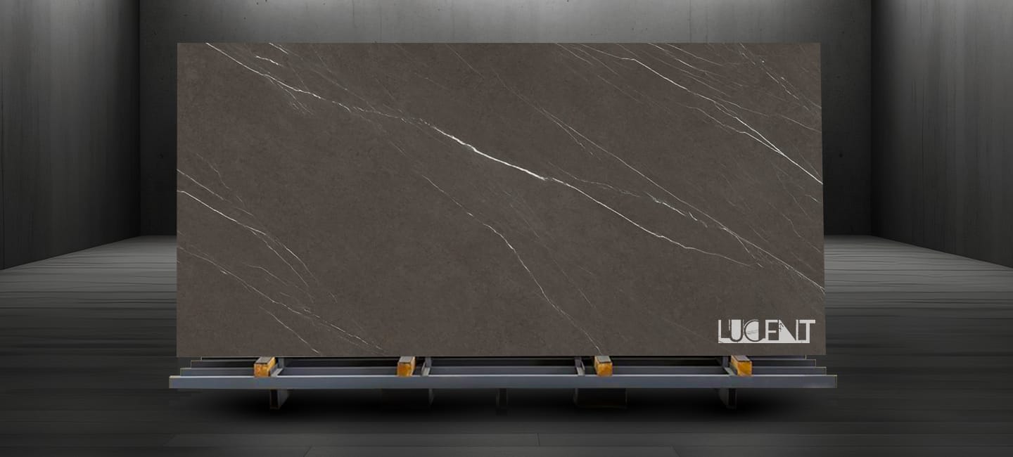 Large slab of Pietra Gray Marble displayed on a stone stand, showcasing its deep gray color and elegant white veining.