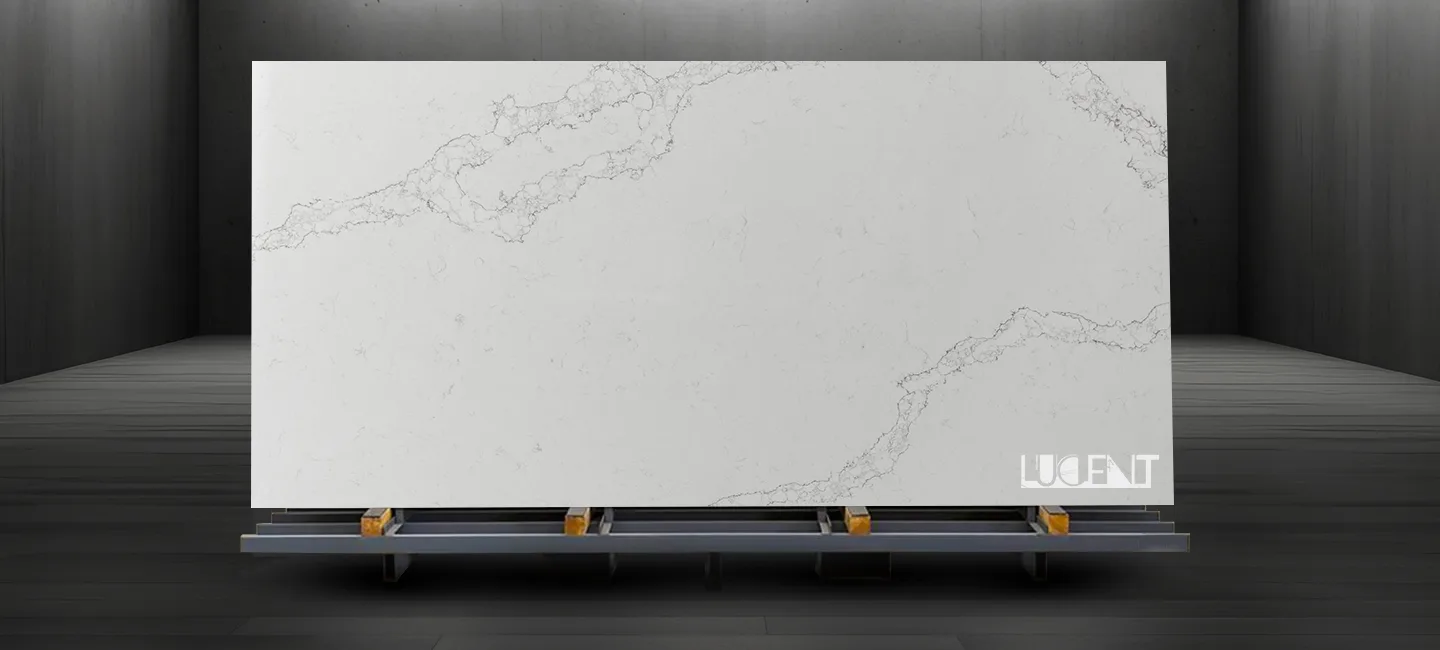 A large slab of Smokey White Marble displayed on a sturdy stand, featuring soft white tones and smoky gray veining in a well-lit showroom.
