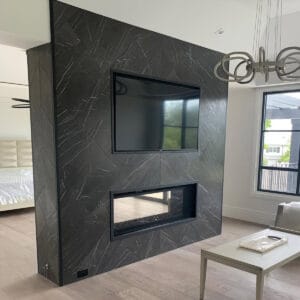 Modern interior featuring a Pietra Gray Marble feature wall with deep gray tones and striking white veining, adding luxury and sophistication.
