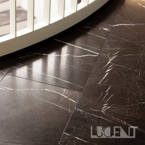 A luxurious foyer with Pietra Gray marble flooring, highlighting the dark tones and white veining of the stone