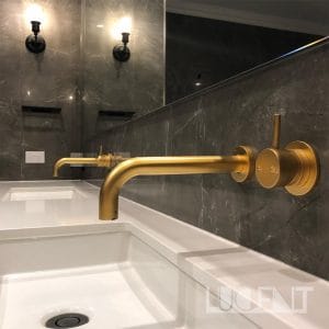 Luxury bathroom featuring Pietra Gray marble flooring, with a freestanding bathtub and elegant lighting