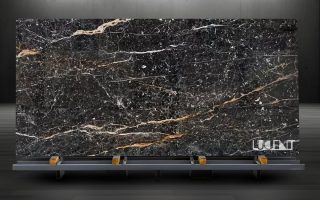 Golden Black Marble Slab on Rack – Ready for Export Golden Black Marble slab displayed on metal holder for export or fabrication
