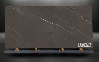 Pietra Gray Marble Slab on Display Stand Large slab of Pietra Gray Marble displayed on a stone stand, showcasing its deep gray color and elegant white veining.